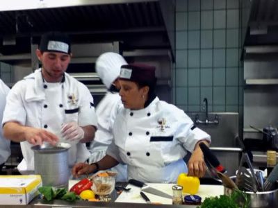Photograph, by Claire Stewart, is of chefs Adrienne Jones and David Caban competing in the Kitchen Feud at the New York City College of Technology on April 25, 2013.