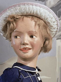 Morton Bartlett doll photograph; girl in blue frock and white hat