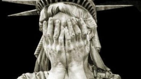 statue of liberty covering face with hands - cropped