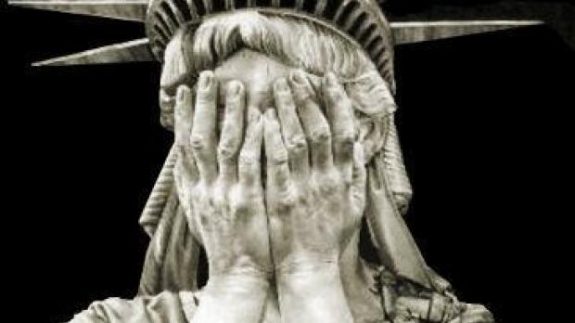 statue of liberty covering face with hands - cropped