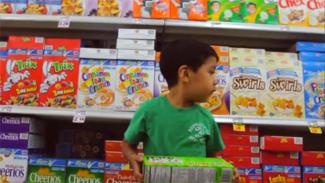 Fed Up documentary; cereal aisle (boy with cereal boxes)
