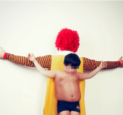 Ronald McDonald and Boy, arms spread, Christ-like