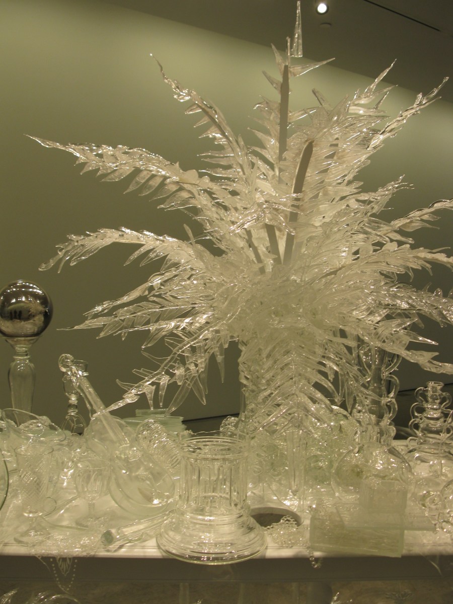 detail from Beth Lipman's "Laid (Time-) Table with Cycads," 2015. Glass, wood, adhesive and paint. 92 x 192 x 57 inches.