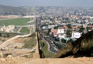 A small fence separates densely populated Tijuana, Mexico, right, from the United States in the Border Patrols San Diego Sector. Construction is underway to extend a secondary fence over the top of this hill and eventually to the Pacific Ocean.