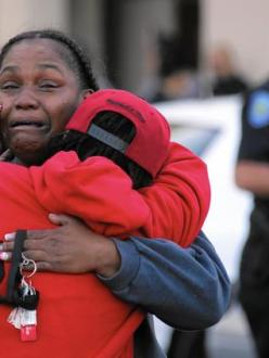 People console one another outside the emergency room entrance to Loma Linda Medical Center after two shootouts in San Bernardino. (Irfan Khan / Los Angeles Times)