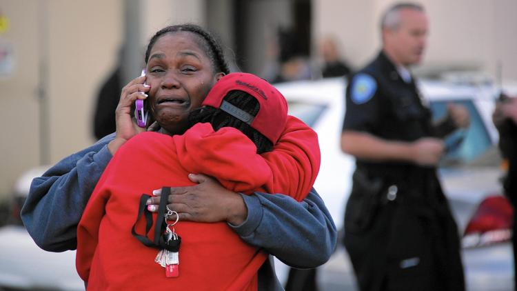 People console one another outside the emergency room entrance to Loma Linda Medical Center after two shootouts in San Bernardino. (Irfan Khan / Los Angeles Times)