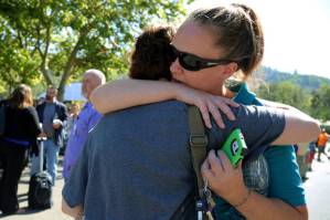 A woman is comforted as friends and family wait for students at the local fairgrounds after a shooting at Umpqua Community College in Roseburg, Ore., on Thursday, Oct. 1, 2015. (AP Photo/Ryan Kang)