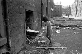 Nick Hedges, "Make life worth living," photographs for Shelter; mother takes her baby inside her condemned tenement block, Gorbals, 1970