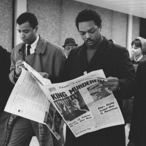 Jesse Jackson reading newspaper telling of Martin Luther King Jr.'s assassintation