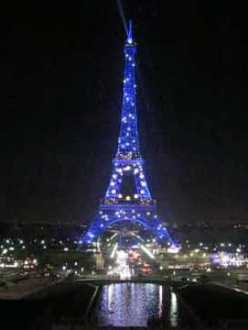 eiffel tower flashing at night, blue with white lights